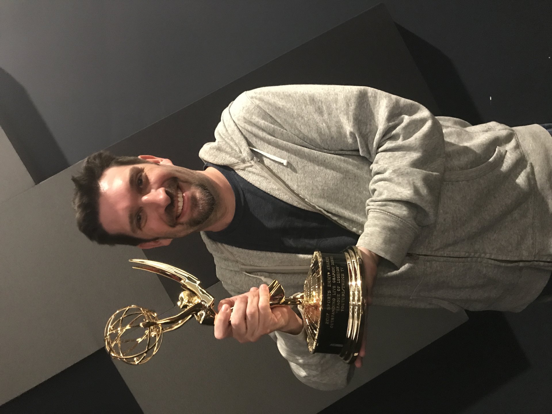 Kevin Scharff holding the Sports Emmy for Outstanding Live Graphic Design
