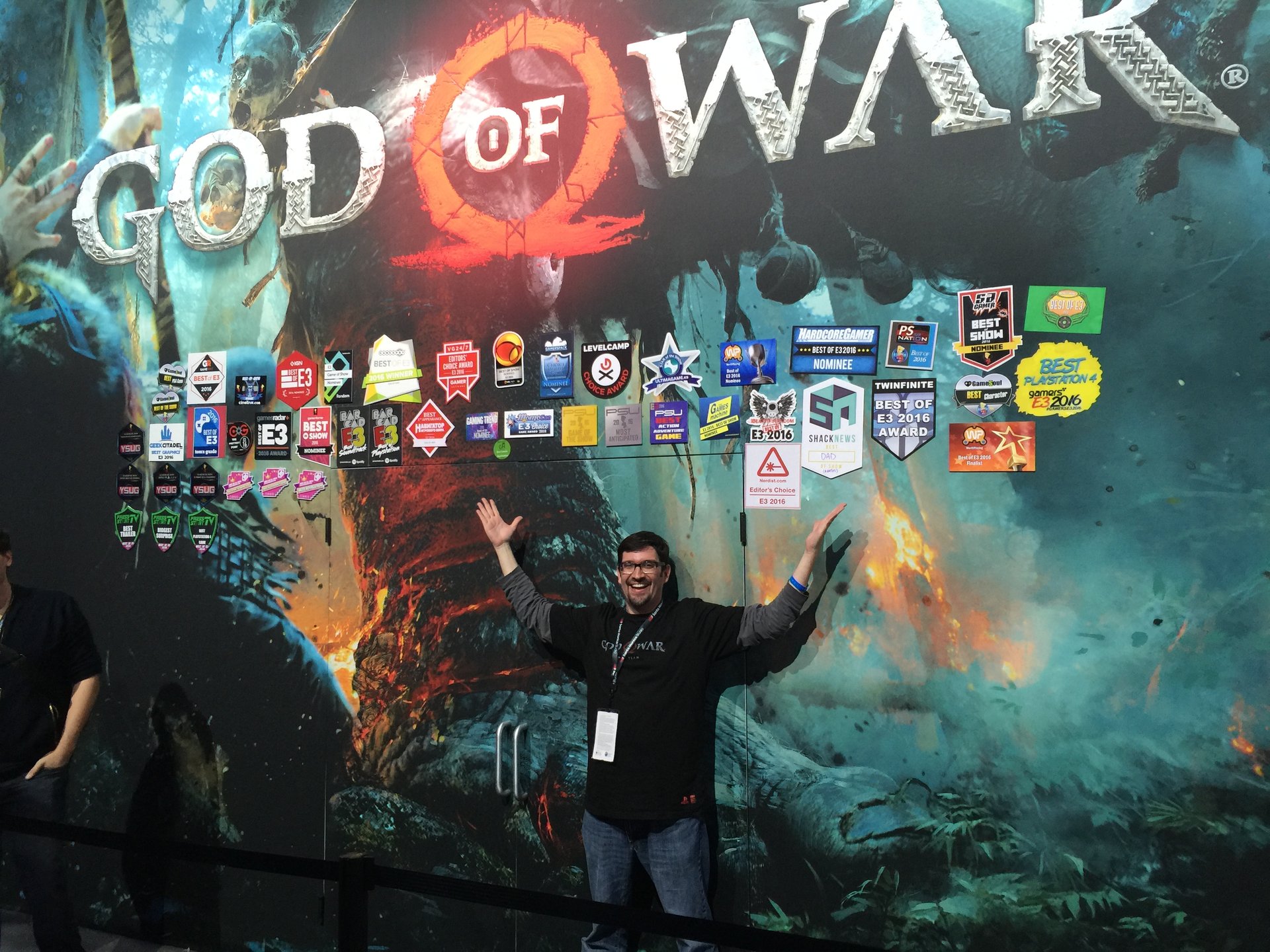 Kevin under the God of War Best of E3 awards wall