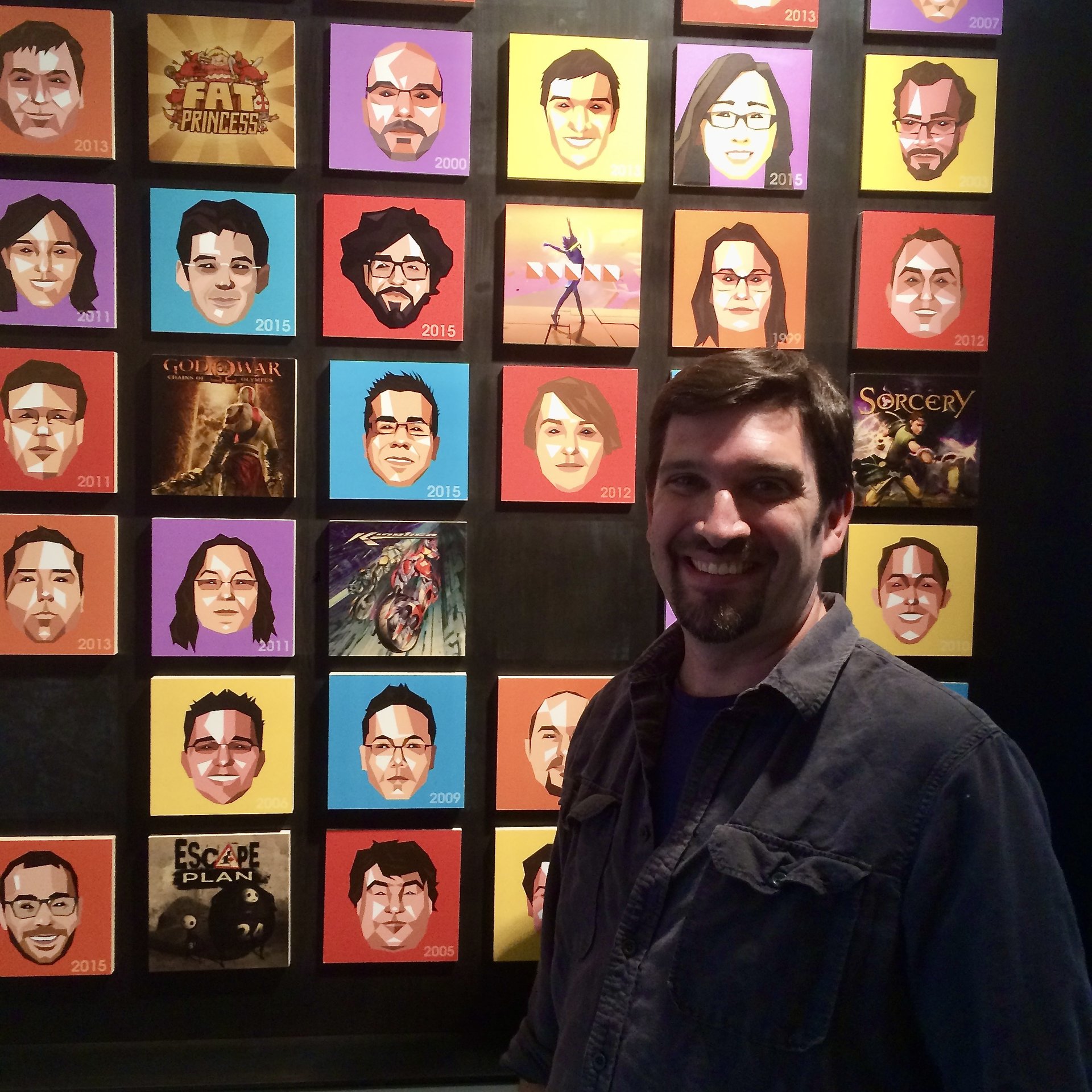 Kevin in front of the Santa Monica Studio developer portrait wall
